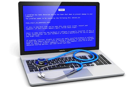 A laptop displaying a blue screen with a stethoscope laying on the keyboard