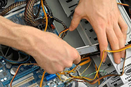 Picture of a set of mans hands replacing a failed hard drive